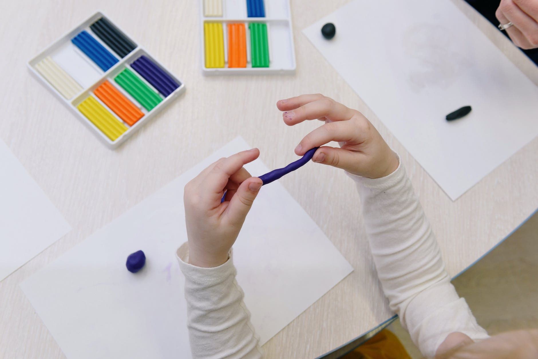 person holding blue modelling clay